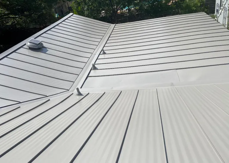 Solar attic fan installed on a metal roof for Roof Ventilation in Oberlin